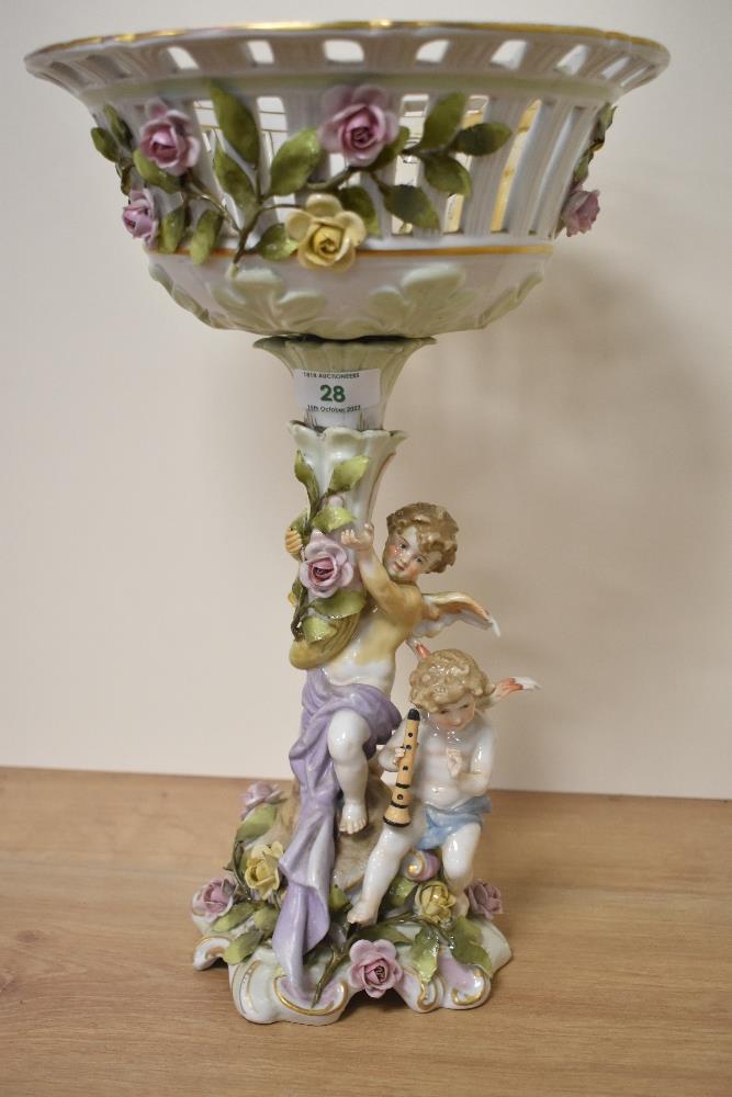 A Capodiamonte porcelain centre piece, with basket to top and cherubs to base.