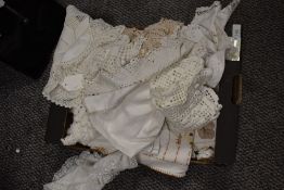 A selection of vintage table linen, including embroidered table cloth and crochet edged mats and