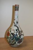A 19th Century Chinese bottle vase, decorated with peacocks and peony flowers, having character mark