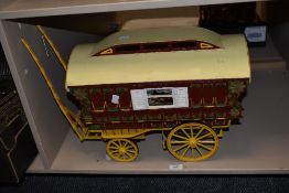 A painted wooden model of a Romany caravan, measuring 80cm long including hames