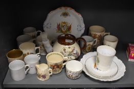 A collection of antique coronation ware, including teapot, beakers and mugs, predominantly 1902