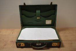 A 1940s green stained leather writing brief case.