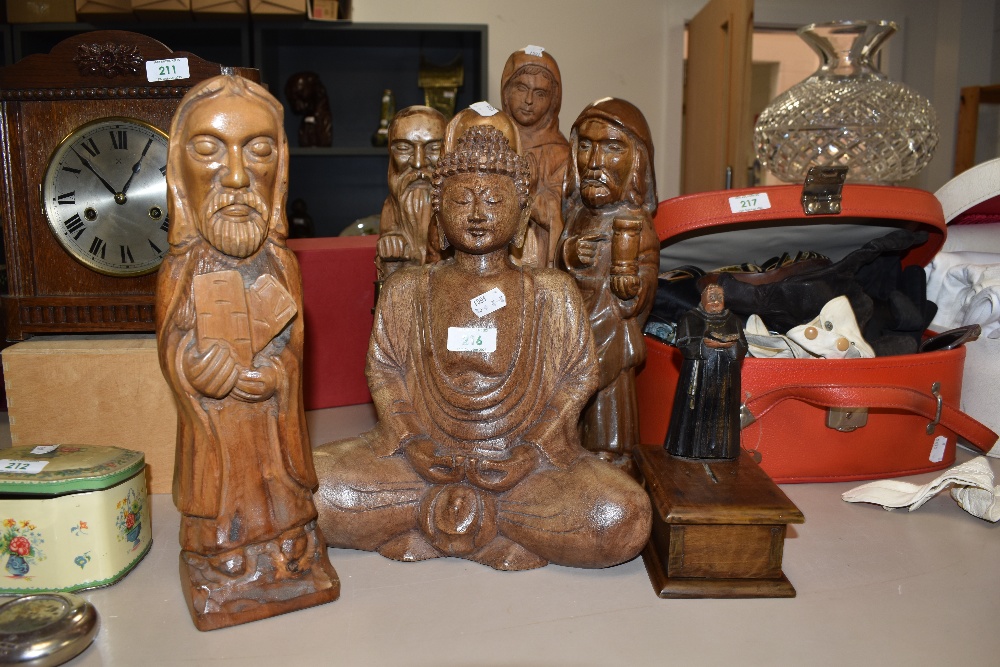 An assorted collection of carved wooden statues of bishops, plus other characters, and a monk form