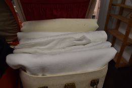 A white leather vanity case containing table cloths