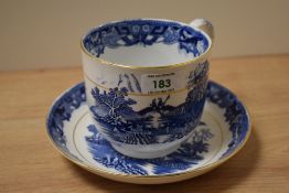 A 20th Century blue and white hot chocolate cup and saucer, decorated in the willow pattern