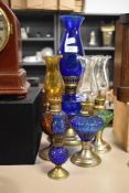 A vintage cobalt blue oil lamp, with pierced metal base, together with four other miniature oil