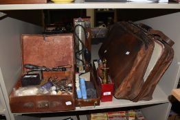 A vintage brown leather doctor's bag and assortment of medical equipment of similar age, to