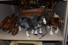 Three novelty heavy work horse ornaments with carts in the style of Beswick pottery.