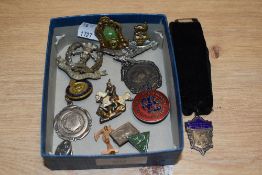 A box of badges and brooches, including military interest.