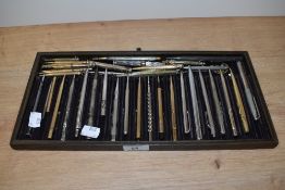 A tray of thirty propelling pencils including white and yellow metal.