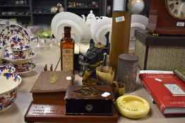 A brass trench art shell vase, horn beakers, a cribbage board, a Scottie dog money bank, and other