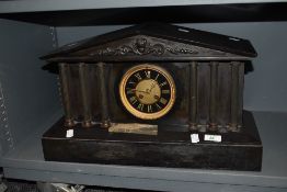 A Victorian black marble mantel clock of architectural design, having Roman hours to gilt heightened