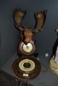Two vintage barometers, one having zodiac signs to border and the other with stag head to top.