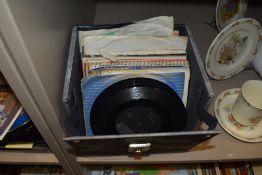 A case of vintage 45 RPM records, including Bobby Darin, Eddie Cochran, Cliff Richard, and Roy