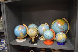 Seven vintage children's tin globes.