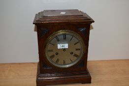 A late Victorian mahogany mantel clock, having a silvered dial, two train movement, and measuring