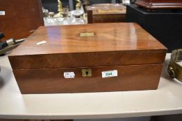 A Victorian mahogany writing slope, the top inset with a blank brass cartouche, opening out to