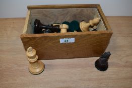 A box of wooden chess pieces.