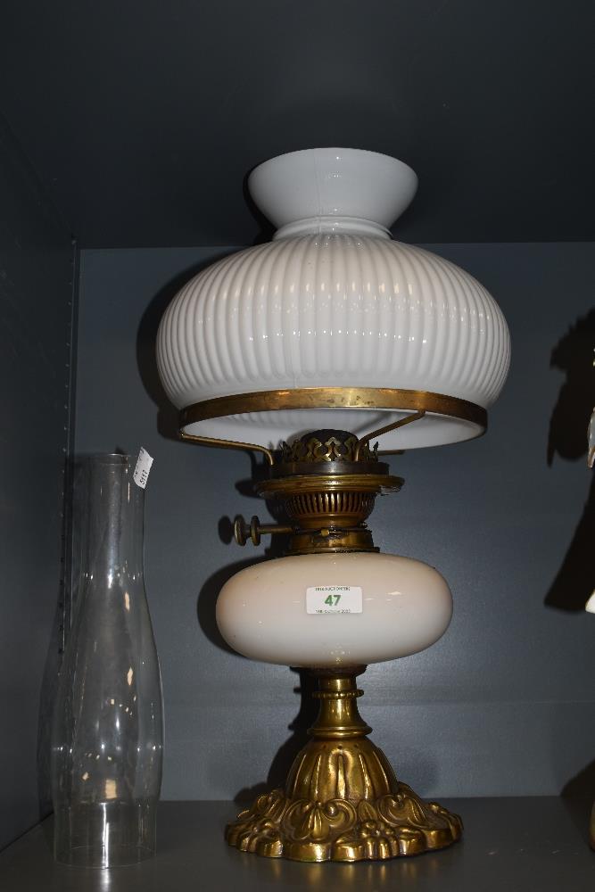 A 20th century oil lamp, having opaque glass shade and reservoir.