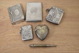 A selection of vesta cases, including one formed as a book with two sides, a hallmarked silver