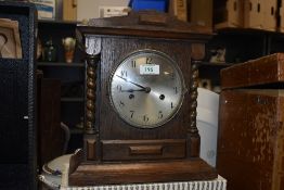 An early 20th Century mantel clock, housed within an oak case with pitched pediment, having a