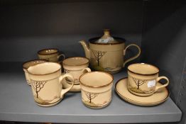 A selection of Denby table ware, having field and house design.