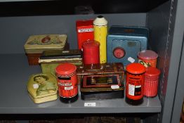 An assortment of vintage tins, including post office money boxes.