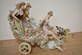 A Sizendorf porcelain centre piece, depicting three maidens in a chariot/troika, with winged