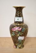 An early 20th century Royal Doulton vase, having claret ground with gilt heightening and hand tinted
