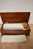 A collection of vintage barograph charts in wooden box.