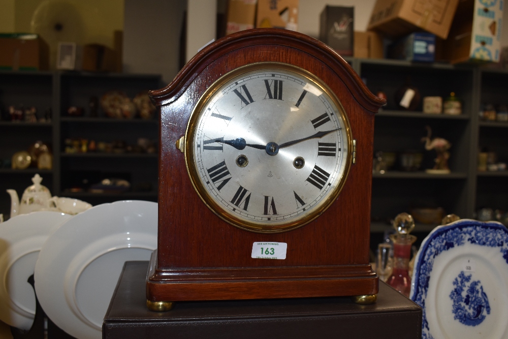 A 20th Century domed top mantel clock, by Gustav Becker, the mahogany case surrounding a silvered