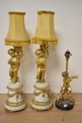 A pair of late 19th/early 20th century ormalu and marble figural table lamps formed as putto, also