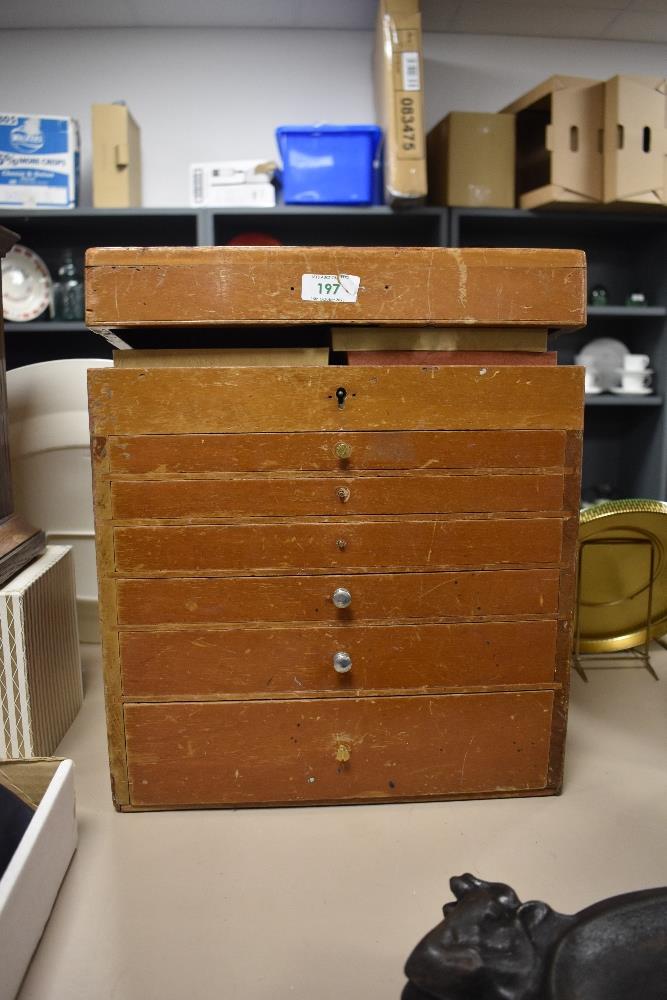 A 20th Century mahogany dentist's cabinet, with lift up top, and six drawers beneath, measuring 38cm