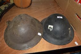 Two WW1 tin helmets.