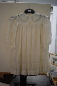 A childrens Edwardian silk dress, with lace, tucks and ladder work.