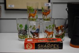 A set of six vintage hi ball glasses featuring various animal prints and a boxed Sharpex razor blade