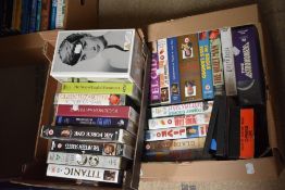 Two boxes of VHS tapes, including Titanic, The Eagle Has Landed, The Astronomers, and The Fifteen