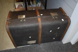 A vintage wooden bound steamer trunk, Isle of Man Steam Packet Company label to side.