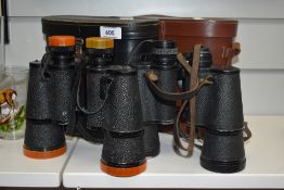 Two pairs of vintage binoculars, Cumbria Deluxe and Denhill Deluxe, with leather cases