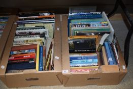 Two cartons of assorted genre books including a selection of guitar music books, car manuals, and