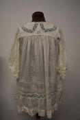A childrens Edwardian silk dress, with lace, tucks and ladder work.