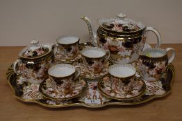 A Royal Crown Derby four setting tea set, comprising Four cups and saucers, teapot, sugar and