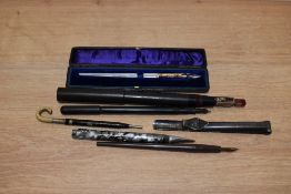 A small selection of writing equipment including dipping pens, Eyedropper in BHR, novelty propelling