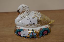 A Royal Crown Derby paperweight in the form of a swan, having silver stopper.