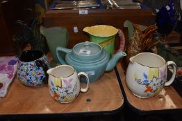 A 1930s Arthur Wood tea pot in matt blue finish, a 1930s Burleigh jug with Lupin decoration, two