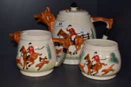 A three piece glazed ceramic tea set, stamped England (possibly Beswick) with hunting theme