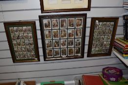 Two framed, glazed and mounted sets of Players cigarette cards, and a similar framed set of cards.