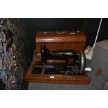 An antique Vesta crank handled sewing machine with bentwood case, serial number 1763409.