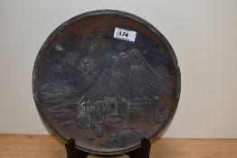 A 19th Century Japanese Antimony ware plate, relief moulded with a farmsteaf, diameter 24cm