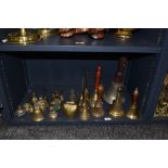 A selection of brass bells, including two cast metal church hand bells.